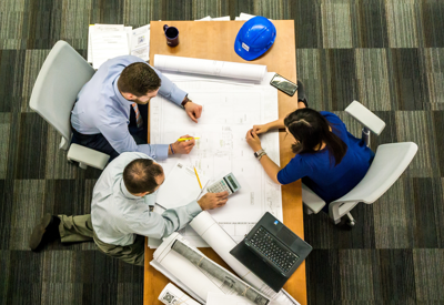 image of office and team working around a table