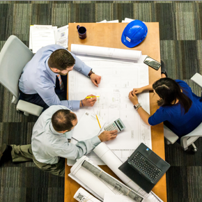 image of office and team working around a table